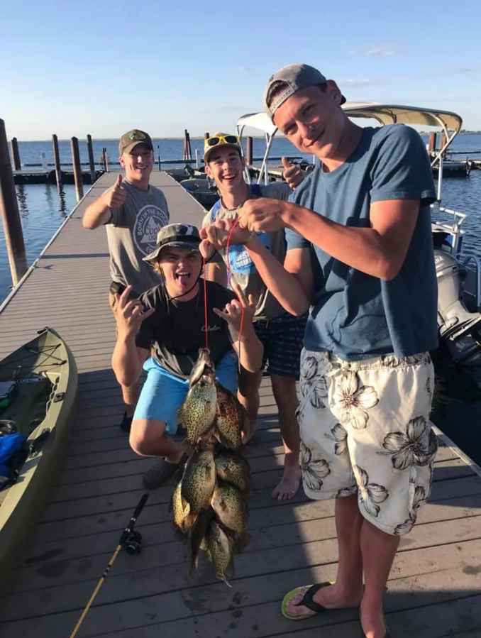 Contributed photo courtesy Lori Webb
Washougal High School graduate Alec Langen (right) poses with friends and a recently-caught fish in an undated photo.