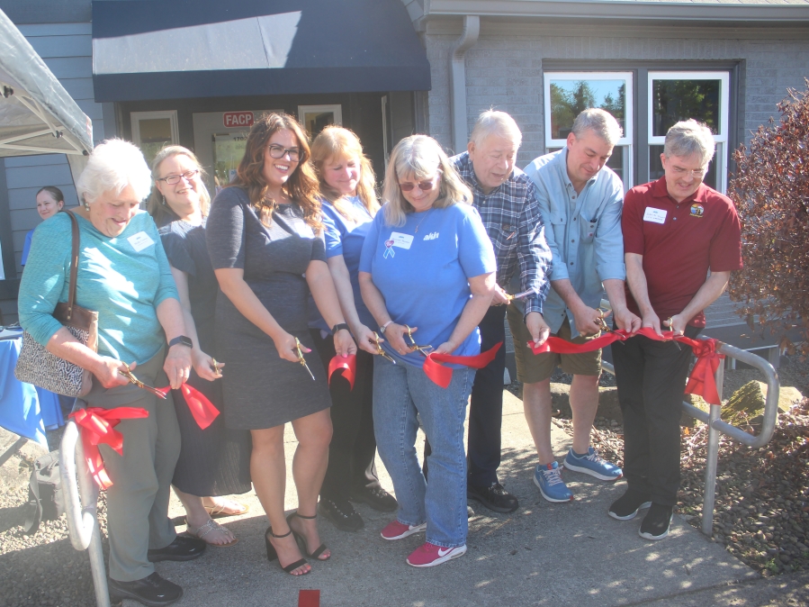 Doug Flanagan/Post-Record 
 Akin employees and city of Washougal leaders, including councilmembers Molly Coston (far left), Ernie Suggs (third from right) and David Fritz (second from right), and City Manager David Scott (far right), cut a ribbon in front of the East County Family Resource Center in Washougal on May 9.