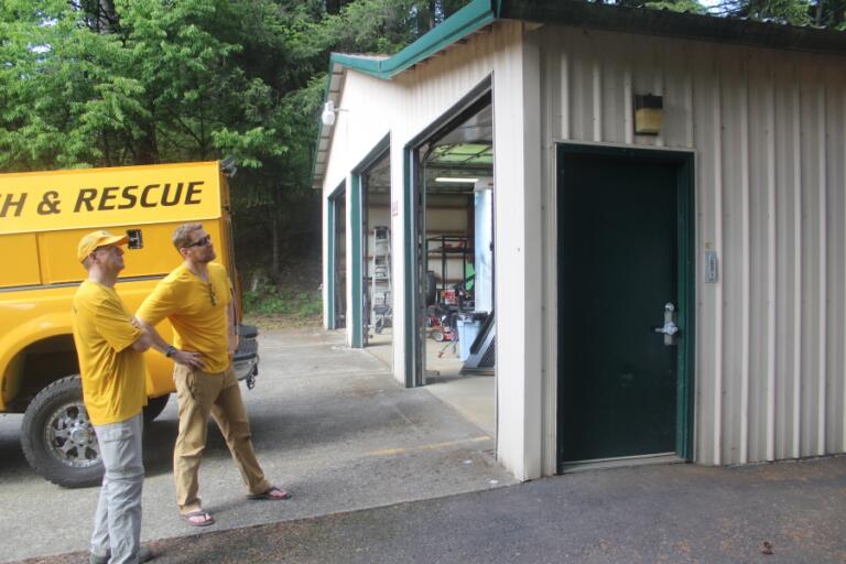 Doug Flanagan/Post-Record 
 Silver Star Search and rescue medical officer Jeff Berner (right) and board member Tom Nichols look at the front of East County Fire and Rescue&#039;s Station 92 on May 13.