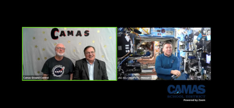 NASA astronaut Dr. Michael Barratt (right) speaks to retired Camas High School physics teacher Dale Croswell (left) and Camas Mayor Steve Hogan from his temporary home on the International Space Station, Thursday, May 23, 2024.