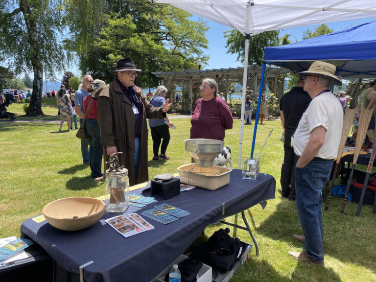 Attendees and volunteers chat at the Two Rivers Heritage Museum display table during the 2023 Parkersville Day event in Washougal.