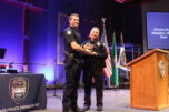 Camas Police Chief Tina Jones (right) presents an award to Camas police officer Casey Handley, the police department's 2023 Sworn Staff Member of the Year, during the inaugural Camas Police Department Awards Ceremony, held at the Grace Foursquare Church in Camas, Thursday, May 23, 2024. (Kelly Moyer/Post-Record) 
