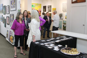 Visitors peruse artwork inside Gallery 408 in downtown Camas during the gallery's grand opening on Friday, May 31, 2024. (Kelly Moyer/Post-Record files)