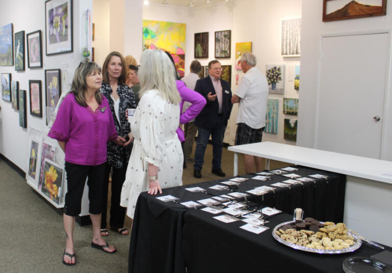 Visitors peruse artwork inside Gallery 408 in downtown Camas during the gallery's grand opening on Friday, May 31, 2024.