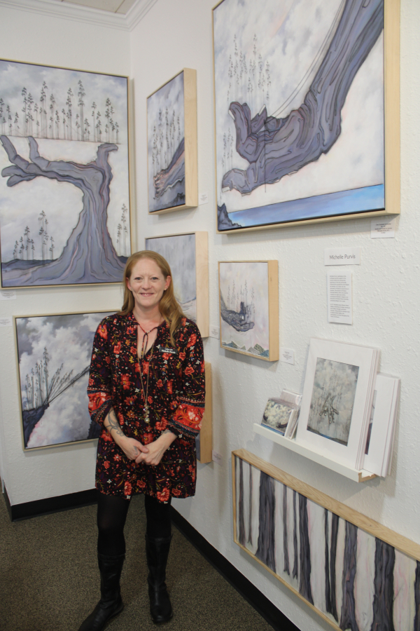 Gallery 408 owner Michelle Purvis stands near her artwork during the gallery's grand opening, Friday, May 31, 2024.