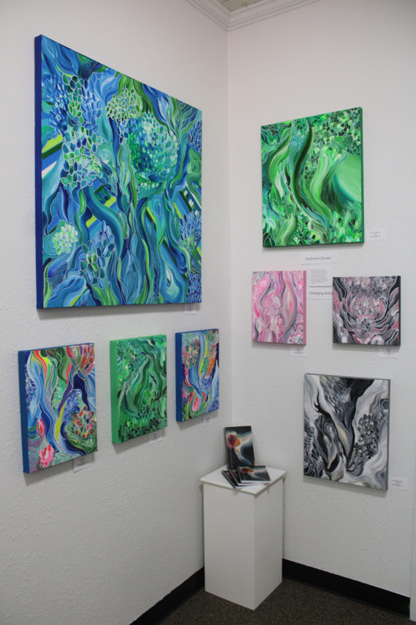 Abstract paintings by Portland-based emerging artist Stephanie Decker hang inside Gallery 408 during the gallery's grand opening, Friday, May 31, 2024.