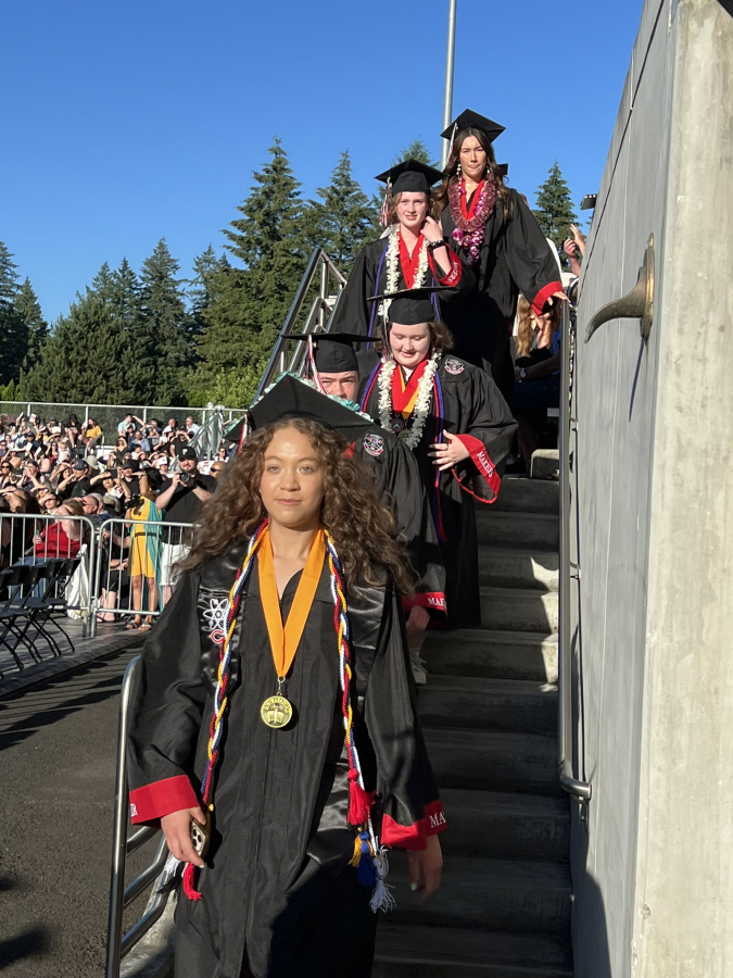 Photo by Doreen McKercher, courtesy of the Camas School District 
 Camas High School 2024 graduates enter the school&#039;s commencement ceremony at Doc Harris Stadium, Friday, June 7, 2024.