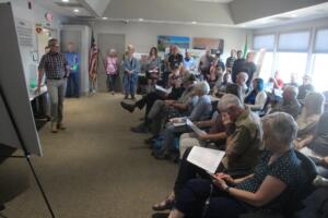 Doug Flanagan/Post-Record 
 Fern Prairie residents listen to Port of Camas-Washougal chief executive director David Ripp (left) speak about the Port's request to annex its Grove Field properties into Clark County's urban growth boundary during an open house on June 5, 2024.