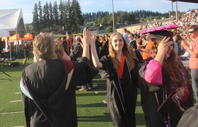 Doug Flanagan/Post-Record 
 Washougal High School graduates high-five teachers at the conclusion of the school&#039;s Class of 2024 graduation ceremony on June 8, 2024, at Fishback Stadium.