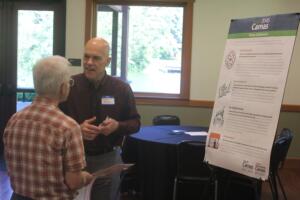 Camas City Administrator Doug Quinn (right) talks to an attendee during the City's 