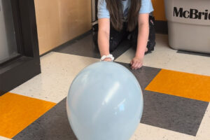 A Columbia River Gorge Elementary School student watches a balloon hovercraft glide along the classroom floor in the spring of 2024. (Contributed photo courtesy of the Washougal School District)