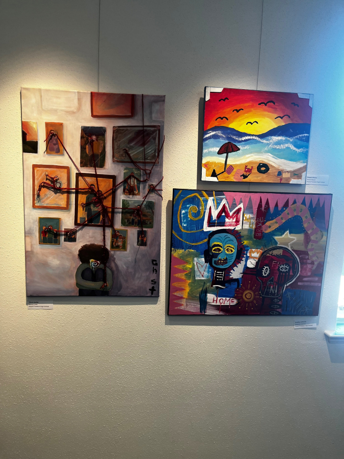 Artwork by Hayes Freedom High School students (clockwise from left) Stick Settje, Druani Olvera and Kayden Johnson hang inside the Second Story Gallery in Camas, Tuesday, July 2, 2024.