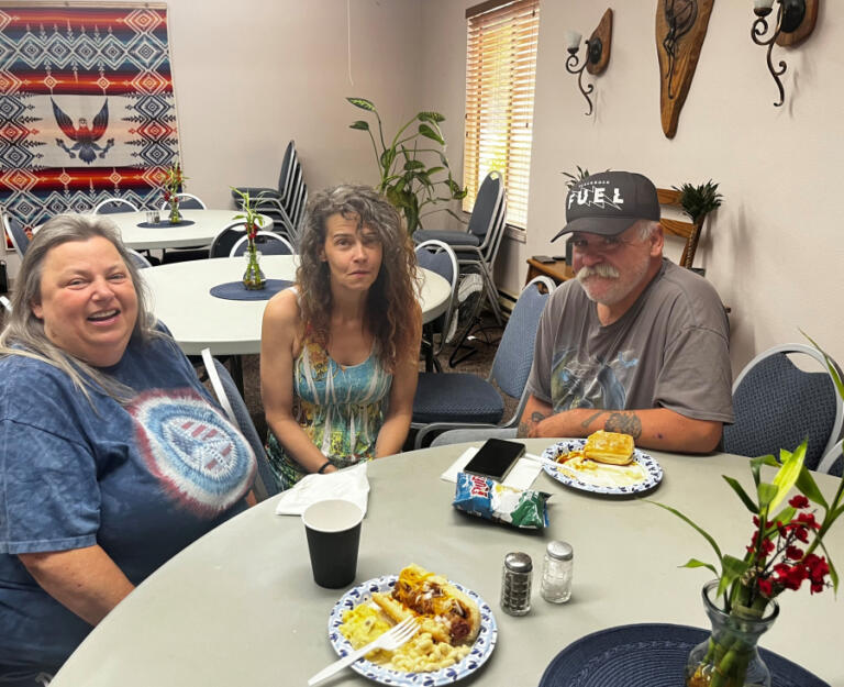 (Left to right) Marci Chapman, Karen Fetroew and Mike Stoll enjoy lunch at a Recovery Cafe pop-up inside St. Anne's Episcopal Church in Washougal, Monday, July 15, 2024.