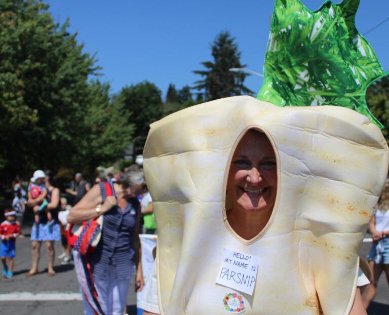 Downtown Camas Association Director Carrie Schulstad dresses like a parsnip to help promote the Camas Farmer's Market during the 2024 Camas Days Kids Parade, Friday, July 26, 2024. (Kelly Moyer/Post-Record) 