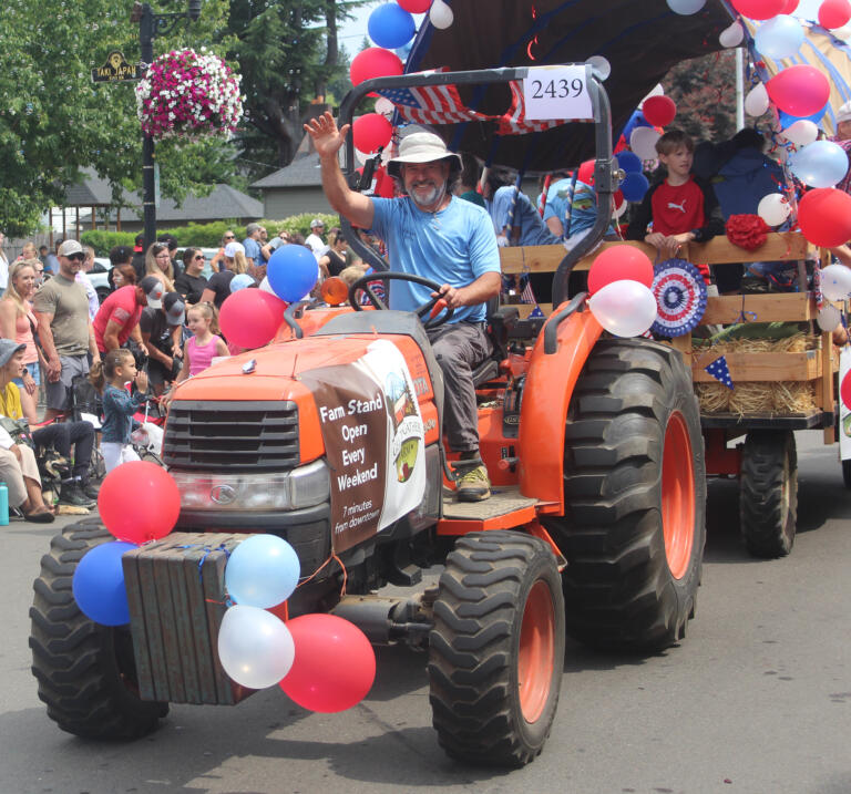 Get To-Gather Farm owner John Spencer waves during the Camas Days festival grand parade on Saturday, July 27, 2024. (Doug Flanagan/Post-Record)