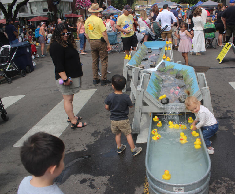 Children play with rubber ducks at the Camas-Washougal Rotary Club's tent during the Camas Days festival on Saturday, July 27, 2024. (Doug Flanagan/Post-Record)