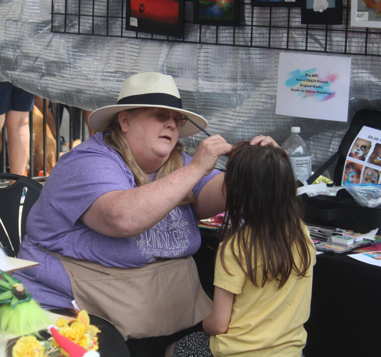 A face-painter paints the face of a child during the Camas Days festival on Saturday, July 27, 2024. (Doug Flanagan/Post-Record)