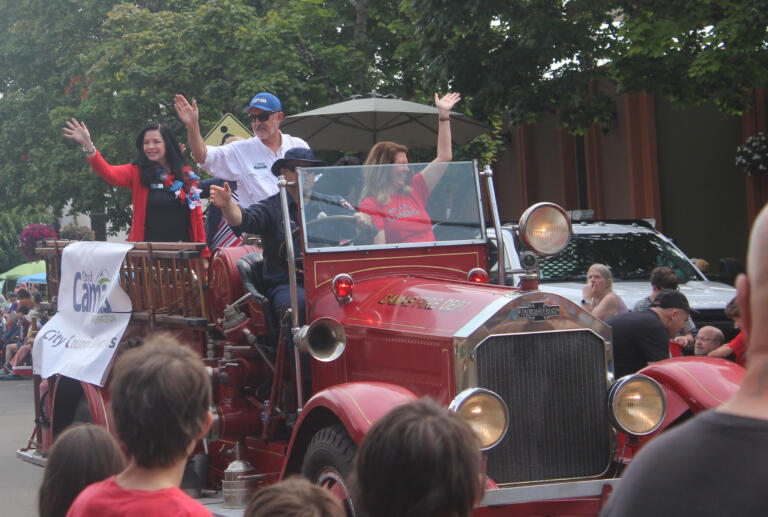 Camas City Council members wave during the festival's grand parade on Saturday, July 27, 2024. (Doug Flanagan/Post-Record)