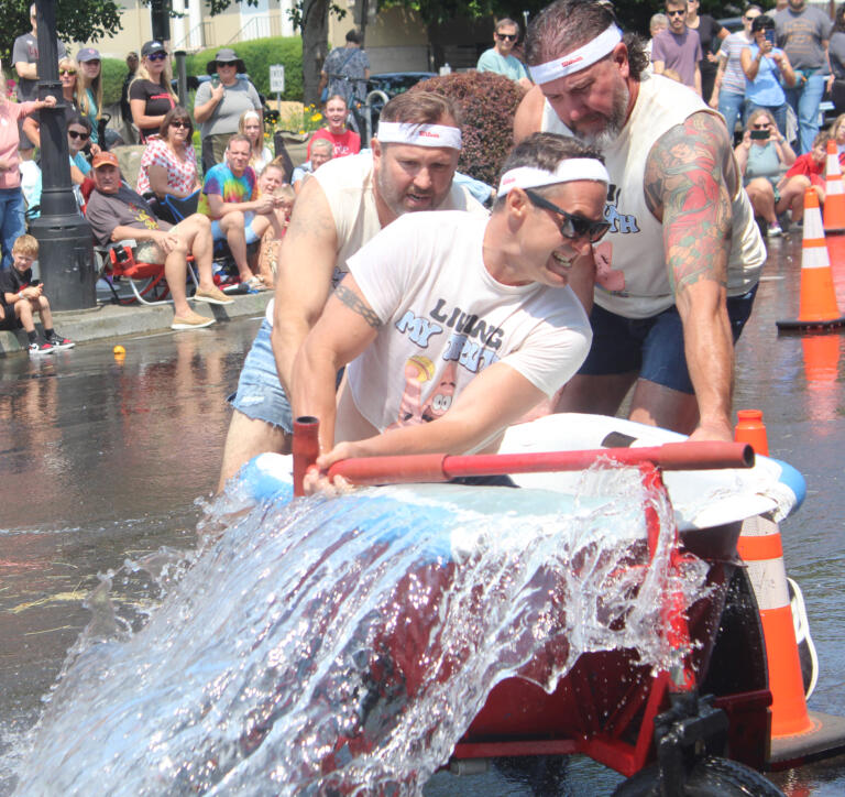 Members of the Hell's Bells team compete in the bathtub races event at the Camas Days festival on Saturday, July 27, 2024. (Doug Flanagan/Post-Record)