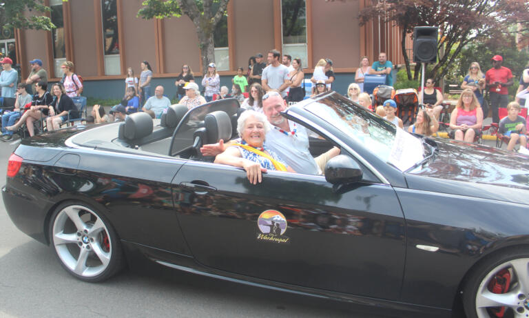 Washougal Mayor David Stuebe drives Molly Coston, the Camas-Washougal Chamber of Commerce's 2024 Citizen of the Year, during the festival's grand parade on Saturday, July 27, 2024. (Doug Flanagan/Post-Record)