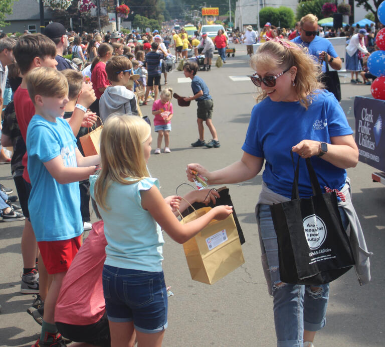 Children receive candy during the Camas Days festival grand parade on Saturday, July 27, 2024. (Doug Flanagan/Post-Record)