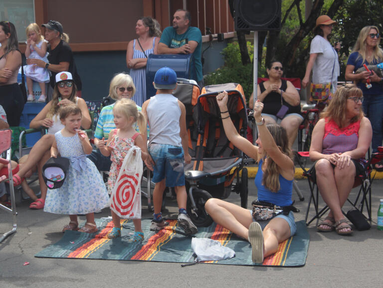 An attendee cheers for a passing vehicle during the Camas Days festival grand parade on Saturday, July 27, 2024. (Doug Flanagan/Post-Record)