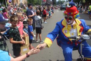 A Shriner clown hands a piece of candy to a child during the 2024 Camas Days Grand Parade, Saturday, July 27, 2024. (Doug Flanagan/Post-Record)