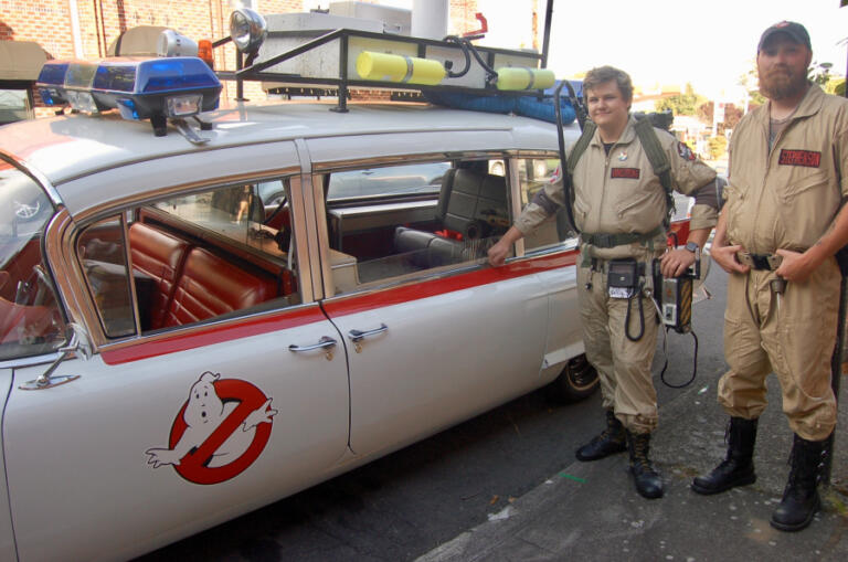 Members of the Ghostbusters PDX group stand by their Ecto-1 vehicle during the 2023 Camas Comic Con.