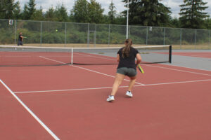 Ainsley Harris, 15, (right) a member of the 2024 Camas High School junior varsity girls tennis team, plays tennis with her father, Steve Harris, on the Camas High School tennis courts, Monday, Aug. 12, 2024. (Kelly Moyer/ Post-Record)