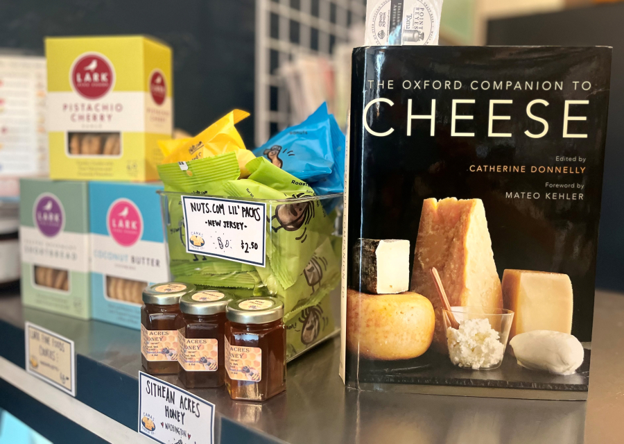 Kelly Moyer/Post-Record 
 A cheese book sits next to an assortment of nuts, honey and other treats inside the  Camas Cheese Co. shop, located at 231 N.E. Fourth Ave., in downtown Camas, on Monday, Aug. 12, 2024.