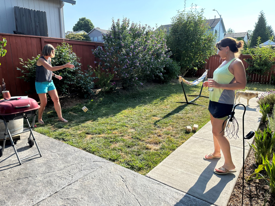 Cheryl Kostanoski (left) and Jennifer Johnson play with one of the Camas Public Library’s new Nature Smart games. (Contributed photo courtesy of Camas Public Library)