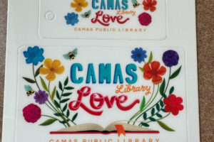 A new Camas Public Library card design celebrates “Camas Library Love.” The card was designed by 2020 Camas High School graduate Hailee Parman, the artist behind the “Camas Love” mural on Northeast Fifth Avenue in downtown Camas. (Contributed photo courtesy of the Camas Public Library)