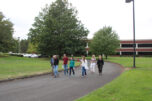 Jasen McEathron (far left), the Camas School District's director of business services, leads a group of community members and other stakeholders on a tour of the school district's Leadbetter campus on Tuesday, Sept. 10, 2024. The campus, located off Northwest Leadbetter Drive and Northwest Lake Road, includes the former Underwriters Laboratories (UL) building (pictured), parking lots, wide swaths of parklike green space and the nearby Skyridge Middle School campus. (Kelly Moyer/Post-Record)