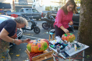 Artists Anna Norris (left) and Susan Fronckowiak decorate pumpkins during the 2023 Pumpkin Pageant in downtown Camas, Friday, Oct. 6, 2024. (Contributed photo courtesy of Downtown Camas Association)