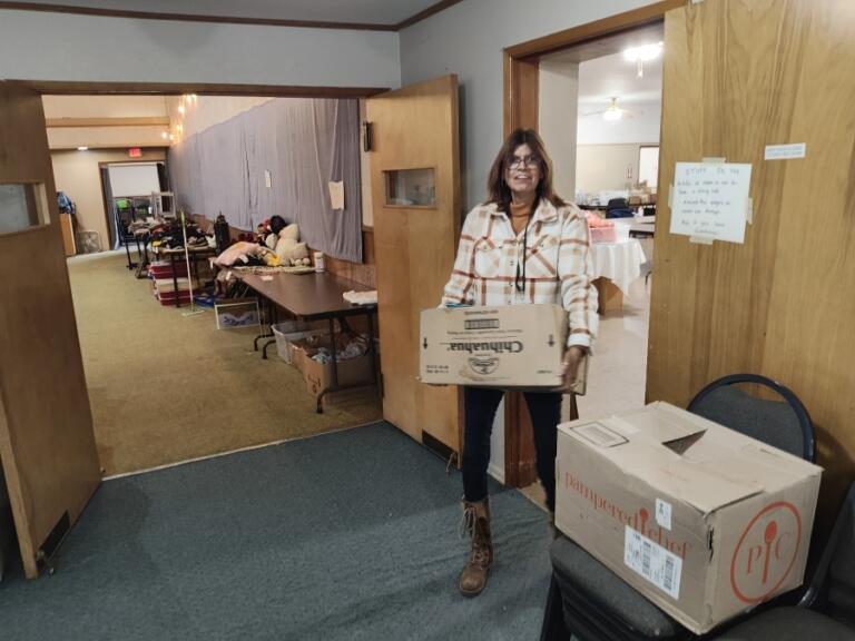 Sandra Renner carries a moving box at The Outpost in Washougal, Sept.