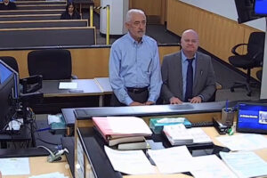 John Svilarich (left) and his lawyer, Vancouver defense attorney Jon McMullen (right) appear in Judge John Fairgrieve’s Clark County Superior Court courtroom on Wednesday, Oct. 2, 2024. (Screenshot by Kelly Moyer/Post-Record)