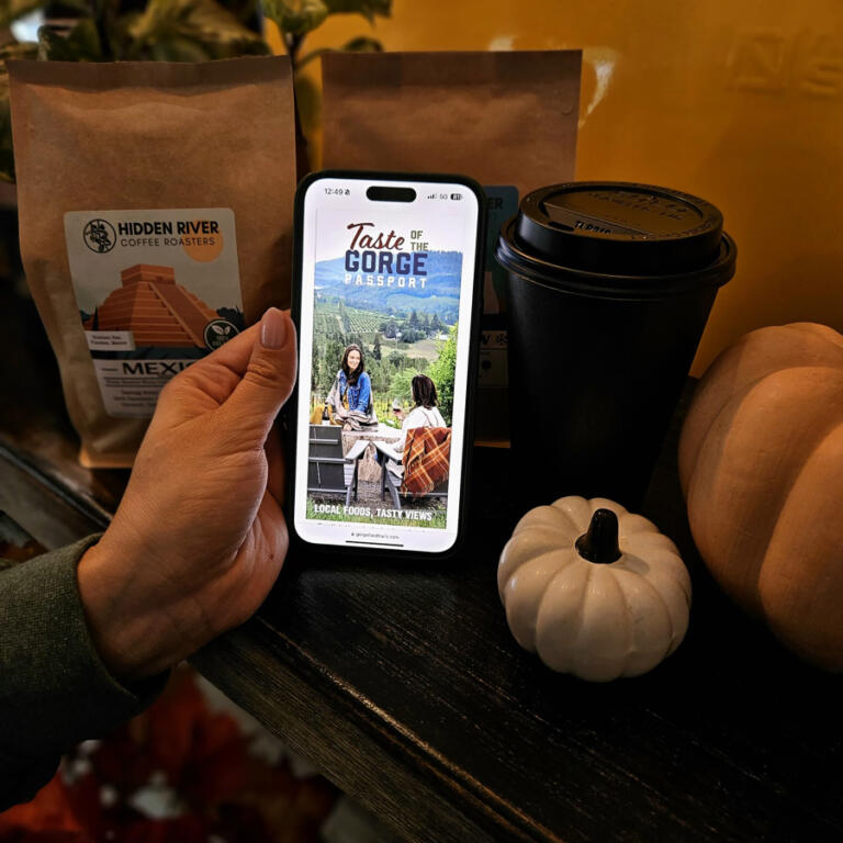 A customer accesses the Columbia Gorge Tourism Alliance&rsquo;s Taste of the Gorge passport at Hidden River Roasters in Camas in 2024.