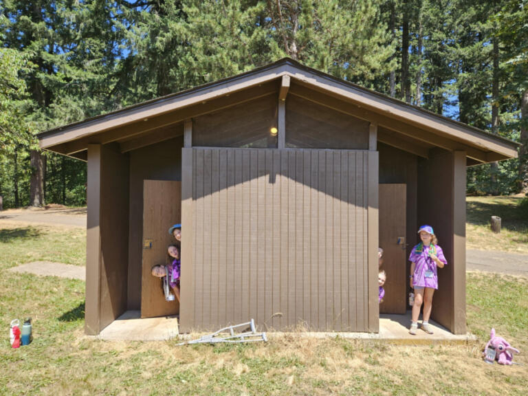 Campers show off new outhouses at Camp Currie funded by a Camas-Washougal Community Chest grant.