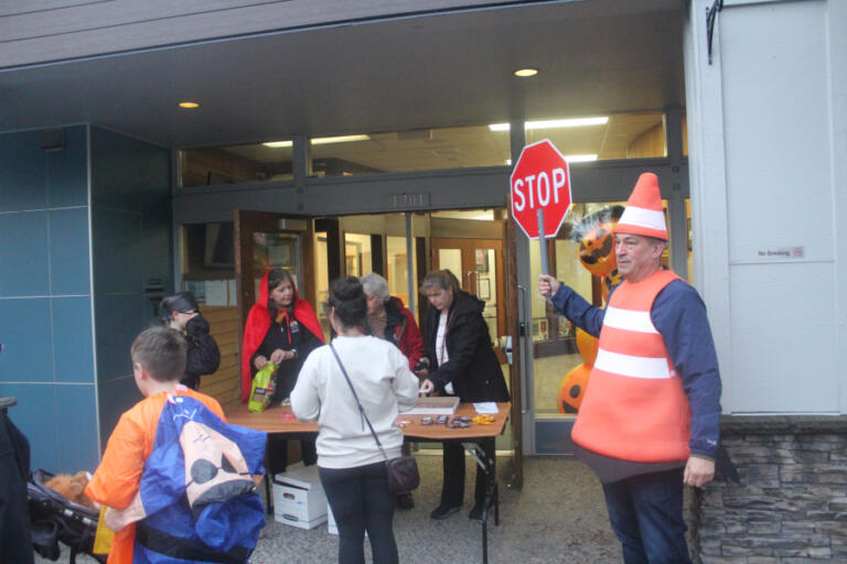 Doug Flanagan/Post-Record
Washougal City Councilman David Fritz (right), dressed as a safety cone &ldquo;directs traffic&rdquo; in the front of Washougal City Hall during the Washougal Trick or Treat on Main Street event on Oct. 31, 2024.