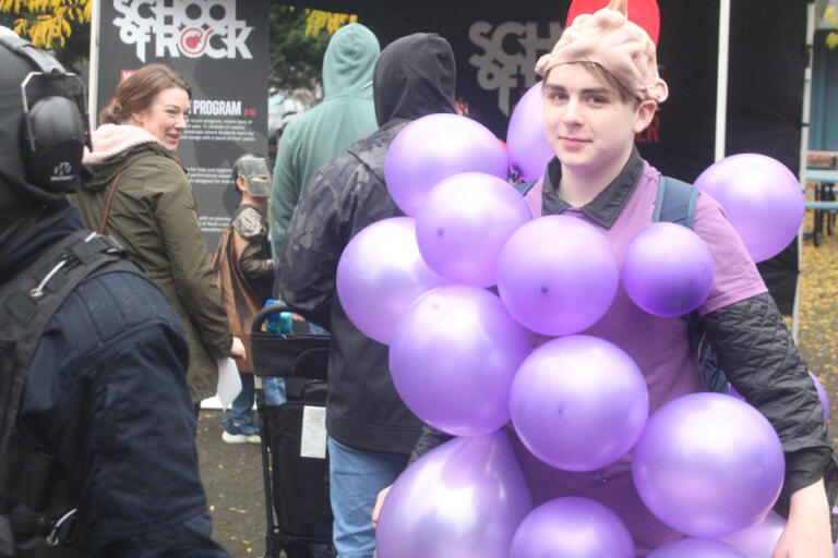 Doug Flanagan/Post-Record 
 A bunch of grapes walks through Reflection Plaza during the Washougal Trick or Treat on Main Street event on Oct. 31, 2024.