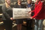 From left to right, Akin family resource specialist Laura Williams, Akin Southwest Washington regional director Adrienne Mason, Camas-Washougal Community Chest (CWCC) treasurer Marianne Reiter and CWCC president Dave Pinkernell hold a $3,500 check at the East County Family Resource Center in November 2024. (Contributed photo courtesy of Dave Pinkernell)