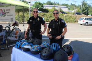 Photos by Kelly Moyer/Post-Record files
Camas Police Chief Tina Jones (left) and her officers hand out free helmets Thursday, July 27, 2023, during a grand reopening event for Camas’ Riverside Bowl Skatepark.