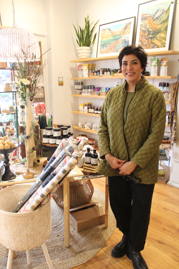 Poppy & Hawk owner Lori Cano stands next to a display of seasonal items inside her Camas retail shop, Nov. 23, 2024.