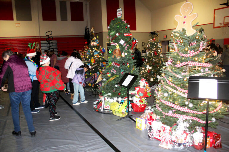 Attendees look at decorated trees during the Washougal Festival of Trees event at Hathaway Elementary School in December 2023.