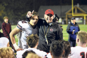 Camas coach Adam Mathieson stands with Beau Harlan (12) as he talks to his team after beating Skyview in a 4A Greater St. Helens League football game at Kiggins Bowl on Friday, Nov. 1, 2024. (Tim Martinez/The Columbian)