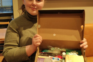 Washougal High School senior Emily Bishop, on Dec. 17, 2024, displays one of several feminine hygiene kits she has created to donate to local homeless shelters. (Doug Flanagan/Post-Record)