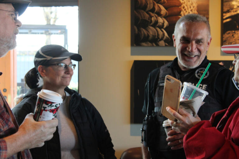 Portland Police Commander Wendi Steinbronn (second from left) listens as Washougal Police Chief Ron Mitchell (second from right) talks to community members at the "Coffee with a Cop" event on Nov. 22, 2019.