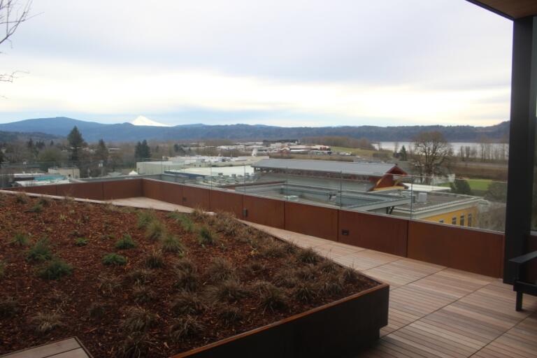 Views from the sixth-floor deck at The Walden, downtown Washougal&rsquo;s newest residential complex, include building rooftops, the Columbia River, and Mount Hood.