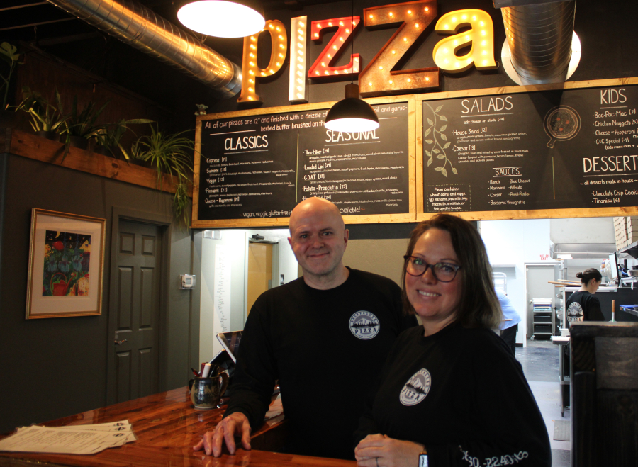 Backpacker Pizza owners Rod Harris (left) and Jami Harris stand behind the counter of their newly opened downtown Camas pizza shop on Thursday, Dec. 12, 2024. (Kelly Moyer/Post-Record)